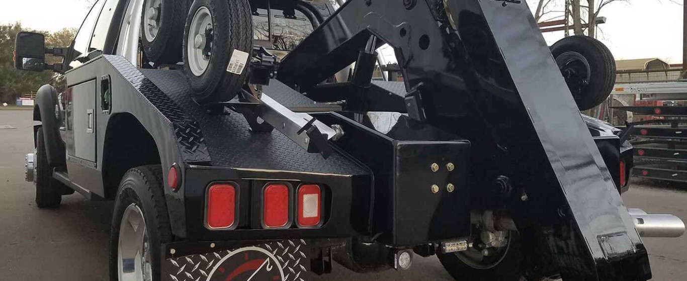 Tow truck with wheel lift equipment ready for jump start service in Lindenhurst, NY